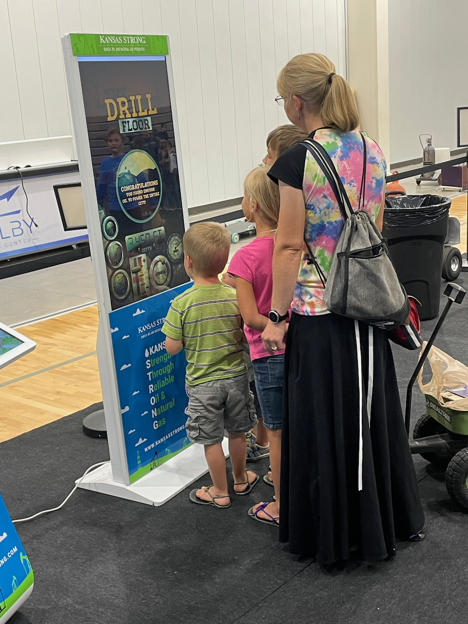 Family in front of a Kansas Strong banner.