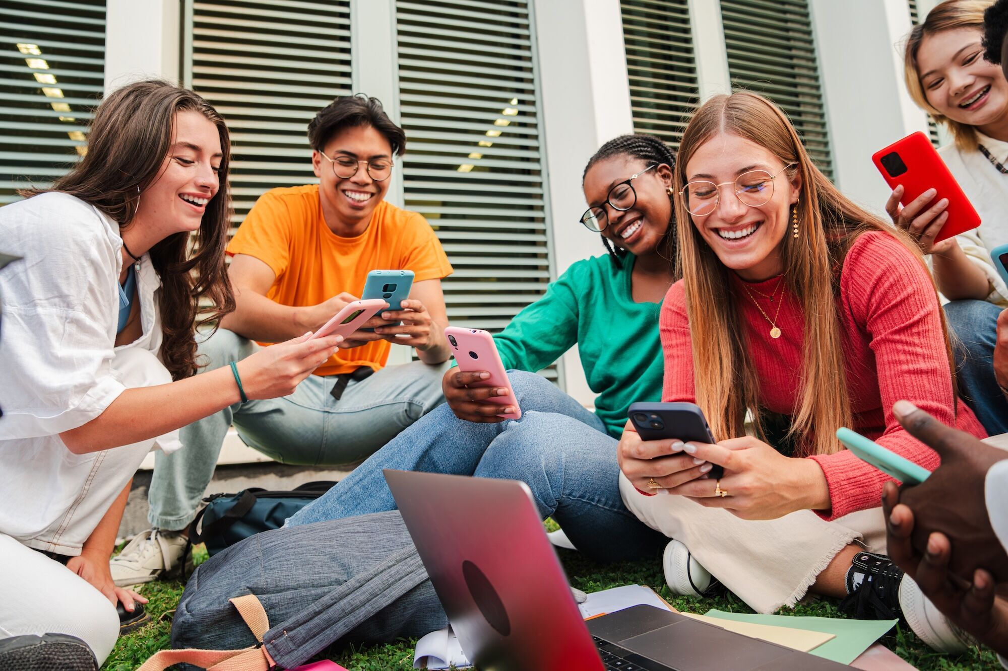 A group of people using phones together.